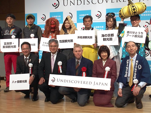 会見後フォトセッションに臨む関係者(前列左端が小林会長)